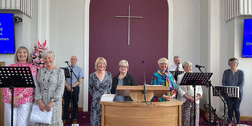 Group of people with music stands and microphones